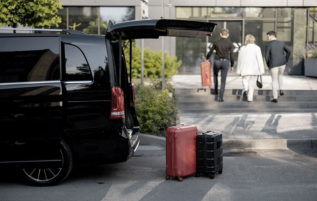 Airport transfer van pickup unloading client luggage