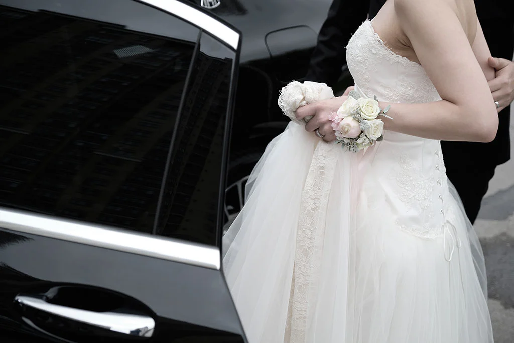 Bride entering a car chauffer service