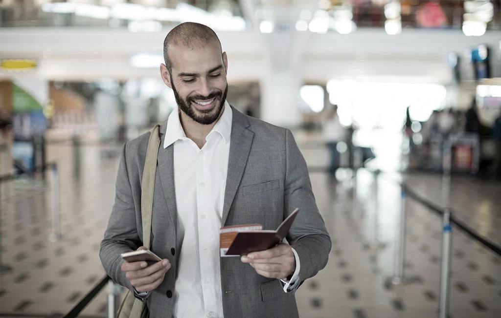 Businessman holding boarding pass at airport