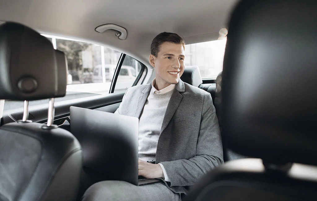 Businessman traveling from airport onboard an airport car service